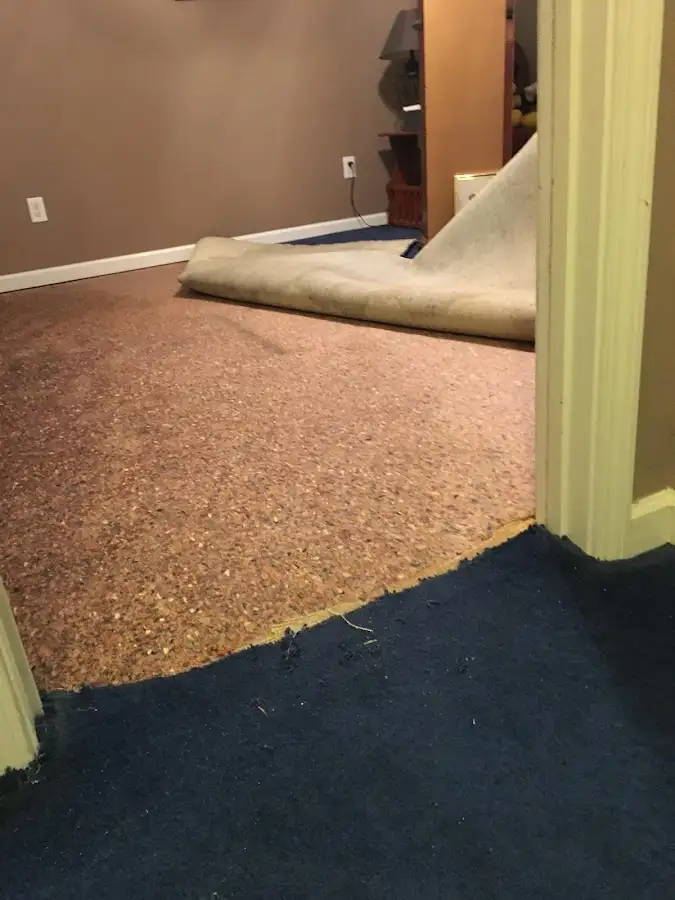 Carpet pad removal revealing water damage during Water Mitigation Services in Caldwell